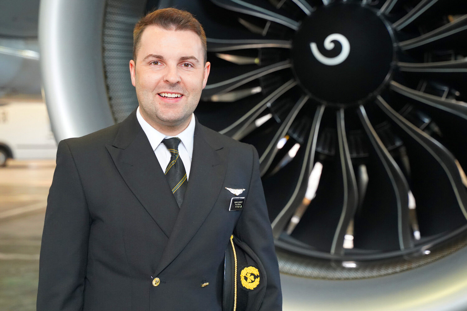 Mark Carney First Officer standing in front of aircraft engine